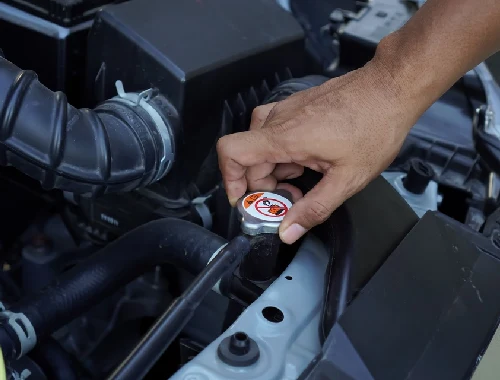 Mechanic repairing radiator and cooling components to prevent overheating