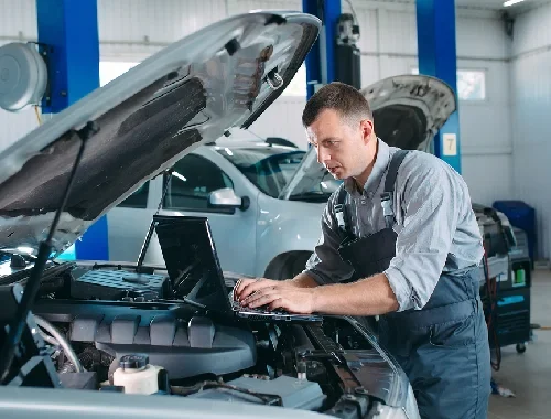 Technician using diagnostic tools to identify engine faults
