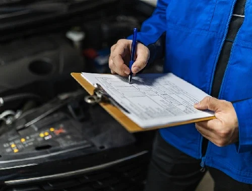 Mechanic performing a manufacturer-based logbook service in the workshop