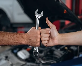 Mechanic completing careful vehicle repair work in the workshop